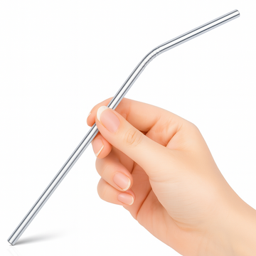 Hand holding a metal straw against a white background