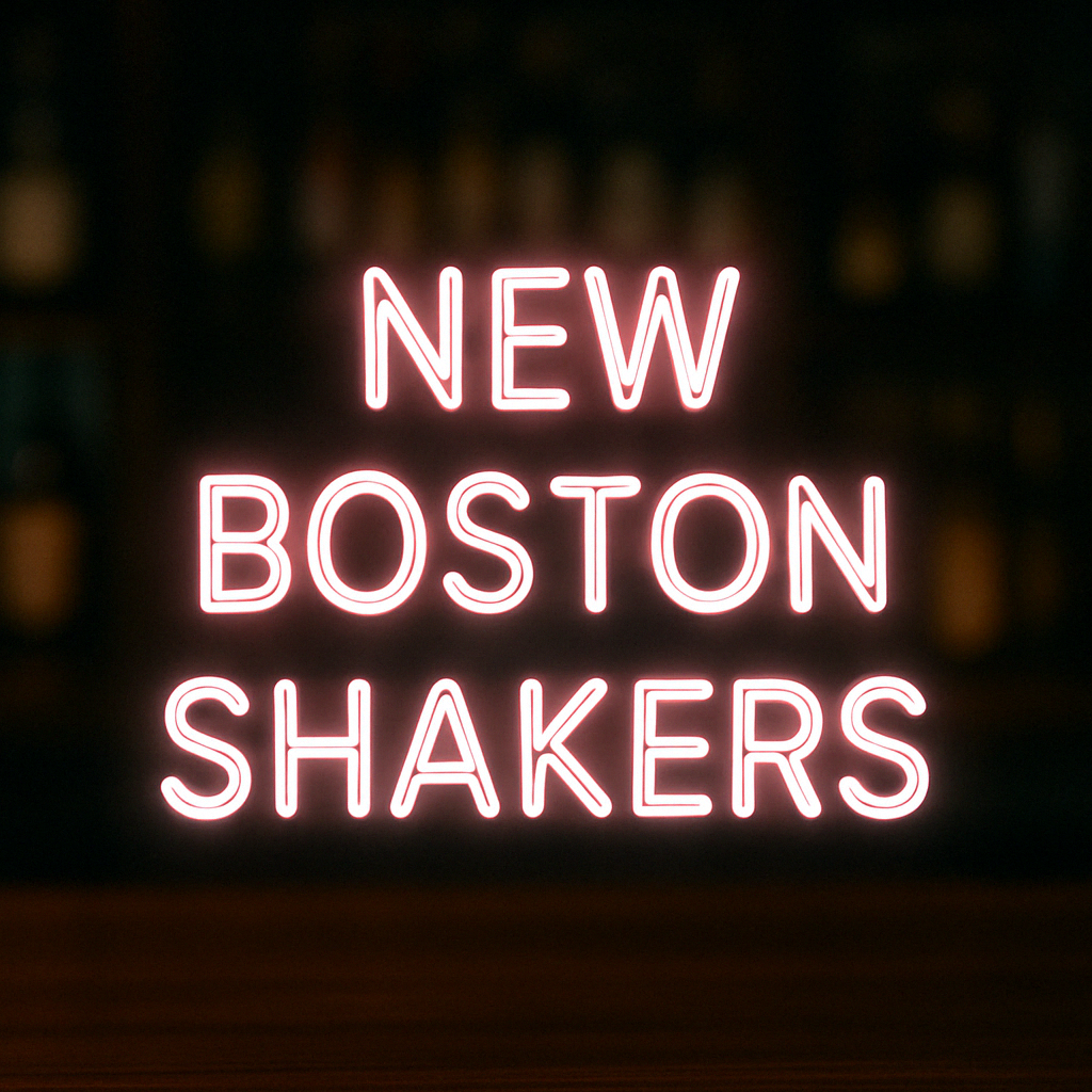  A stainless steel Boston cocktail shaker placed on a bar counter with a glowing neon sign in the background reading “Exclusively at BarBits – Our New Premium Boston Shakers”.