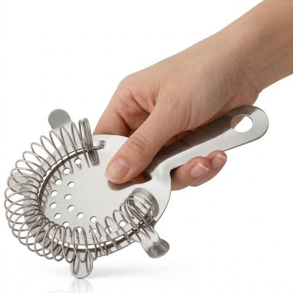 A stainless steel cocktail strainer held by a person's hand against a white background.
