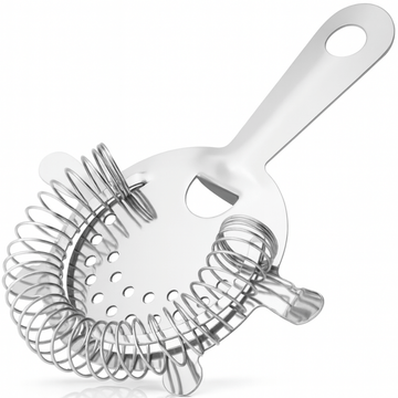 A polished stainless steel four prong Hawthorne cocktail strainer displayed diagonally on a white background, showing its coiled spring and long handle.