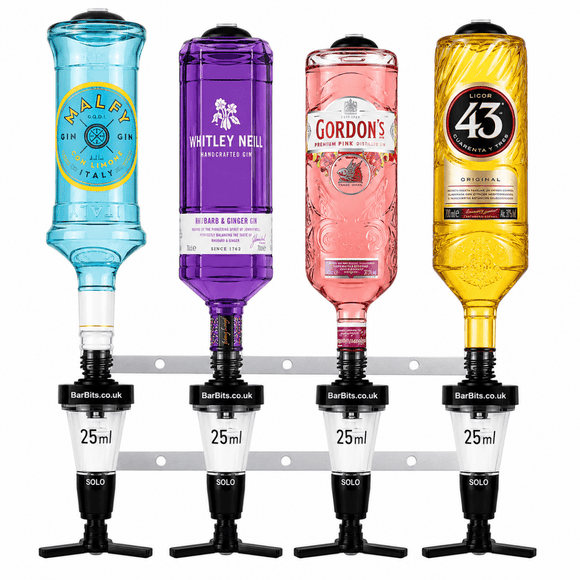 Four BarBits Solo 25ml spirit measure bottles mounted on a metal rack, filled with blue, purple, pink, and gold liquids. The bottles feature colorful glass bodies with black and white measurement sections and black spouts.