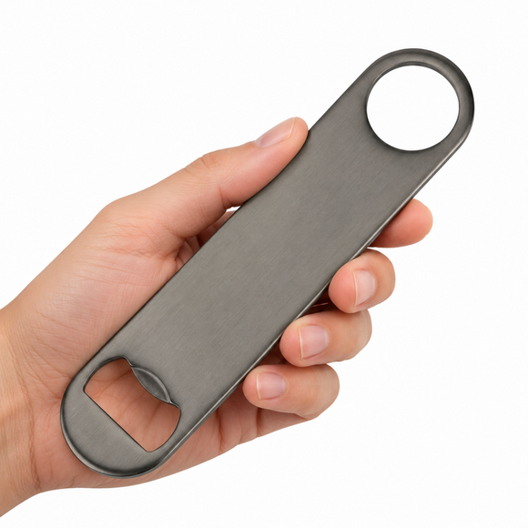 A hand holding a long, slim gunmetal bottle opener with a circular ring at one end and a bottle-opening slot at the other, shown against a plain white background.