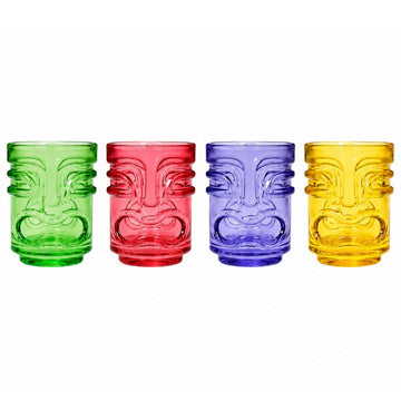 Four colorful tiki-style shot glasses with embossed face designs, shown in green, red, blue, and yellow on a white background.