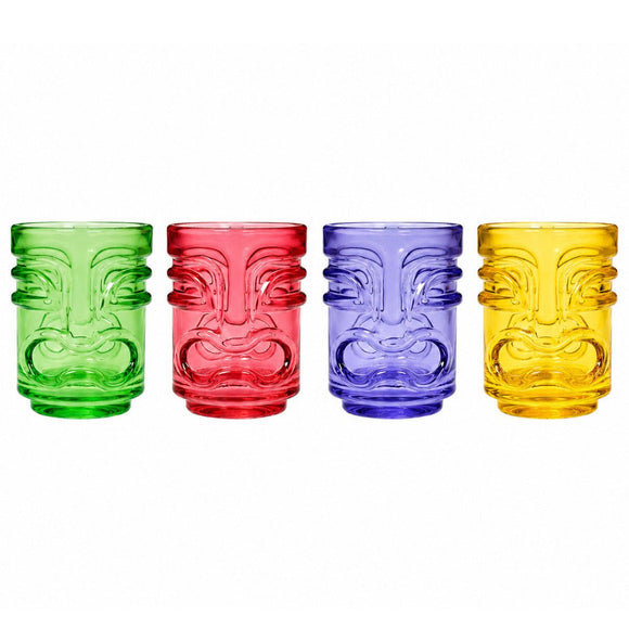 Four colorful tiki-style shot glasses with embossed face designs, shown in green, red, blue, and yellow on a white background.