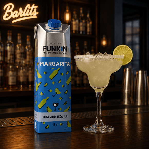 A 1L carton of Funkin' Margarita pre-batched cocktails stands on a bar counter next to a prepared margarita glass with a lime wheel garnish, with a blurred bar interior and a Barlits sign in the background.