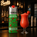 A 1L carton of Funkin Pre-Batched Cocktails Strawberry Daiquiri stands on a bar counter next to a prepared pink-red drink in a stemmed glass with a strawberry garnish. The background shows a dimly lit bar interior with bottles and a lit 'Bartlets' sign.