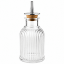 Clear glass Bitters bottle with a cork stopper on a white background