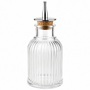 Clear glass Bitters bottle with a cork stopper on a white background