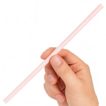 Hand holding a pink straw against a white background