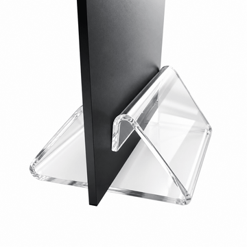 Clear acrylic triangular display stand holding a black vertical board, photographed on a white background.