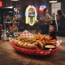Hot dog with fries and a bottle of Coca-Cola on a wooden table in a bar setting.