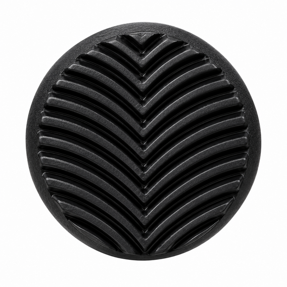 A round black textured cocktail muddler end with a raised chevron pattern, shown against a plain white background.