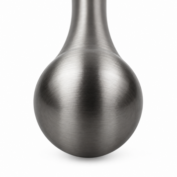 A close-up of a gunmetal cocktail muddler from barbits  shown against a plain white background.