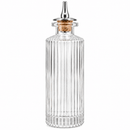 A clear ribbed bitters glass bottle with a cork stopper and a silver metal pour spout, shown on a plain white background.