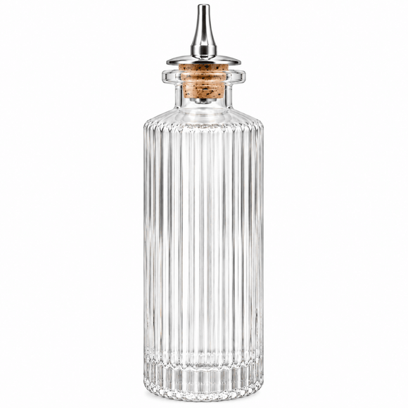 A clear ribbed bitters glass bottle with a cork stopper and a silver metal pour spout, shown on a plain white background.