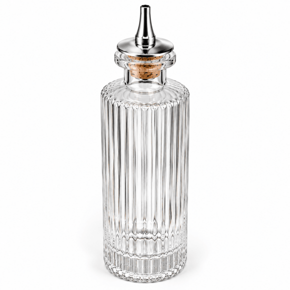 A clear ribbedVictorian Glass Bitters Bottle 145ml metal pour spout and a cork stopper, shown on a plain white background.
